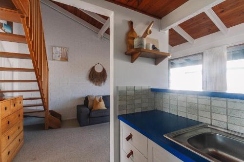 a kitchen with a sink and a counter top at Pippi Beach Loft in Yamba