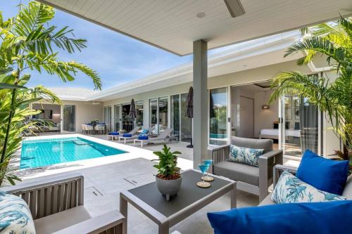 an open living room with a pool and a villa at Big & Stylish 5 Bed 4 Bath Private Garden Pool Villa at Thongson Bay Beach in Koh Samui 