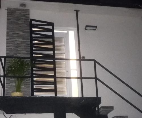 a staircase leading to a door with a window at Ramona loft in Villahermosa