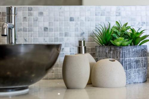 a counter with a sink and a bowl and plants at Big & Stylish 5 Bed 4 Bath Private Garden Pool Villa at Thongson Bay Beach in Koh Samui 