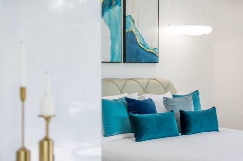 a group of blue pillows sitting on a bed at Big & Stylish 5 Bed 4 Bath Private Garden Pool Villa at Thongson Bay Beach in Koh Samui 