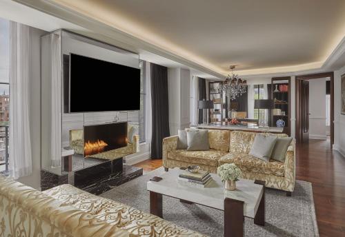a living room with a couch and a fireplace at Rosewood Washington DC in Washington