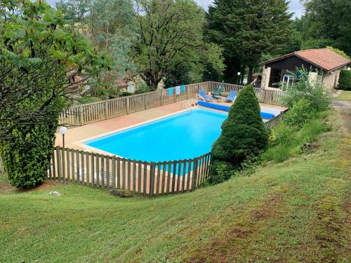 a swimming pool with a fence around it at Hotel Colombié in Gorses