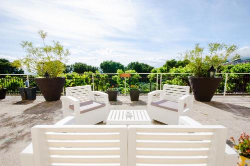 a group of white chairs sitting on a patio at Albergo Villa Gaia in Chianciano Terme