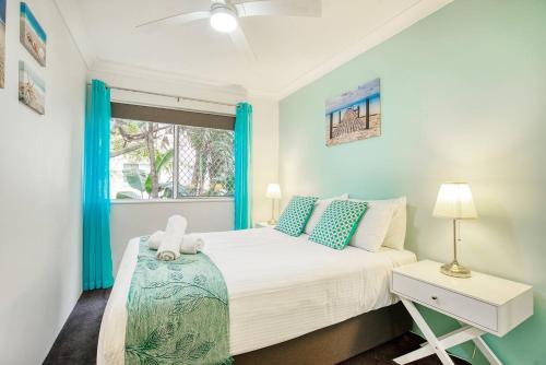 um quarto com uma cama e uma janela em Poolside Paradise Grove at Burleigh Heads em Gold Coast