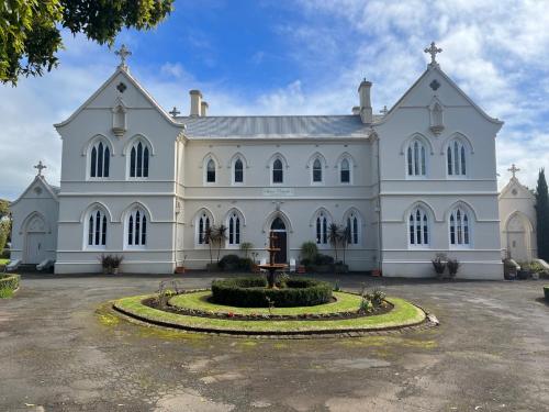 a large white building with a fountain in front of it at Convent at Koroit in Koroit