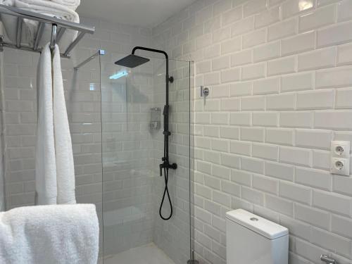 baño con ducha, aseo y puerta de cristal en C4 Exclusiva zona Madrid en Madrid