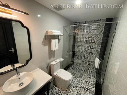 a bathroom with a shower and a toilet and a sink at Moma Paris Hotel Ninh Bình in Ninh Binh