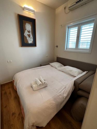 a bedroom with a bed with two towels on it at Family Park apartment with 2 bedrooms in Tel Aviv
