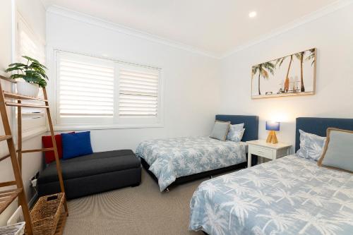 a bedroom with two beds and a window at Gwydir Court 1 in Forster