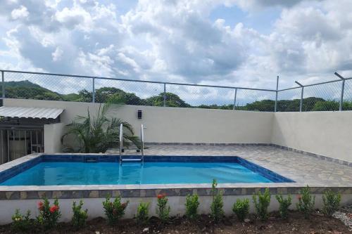 a swimming pool in the backyard of a house at Estrella de Mar Home in Jobos