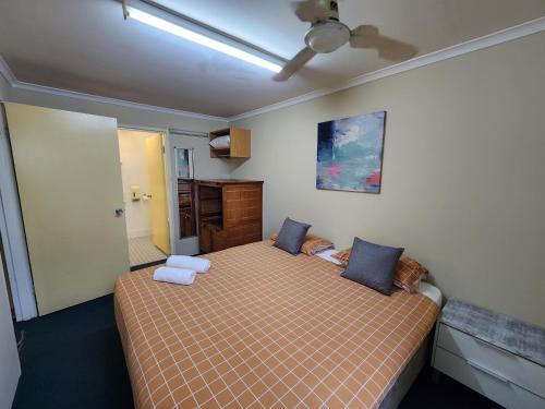 a bedroom with a bed and a ceiling fan at Perth City Apartment Hotel in Perth