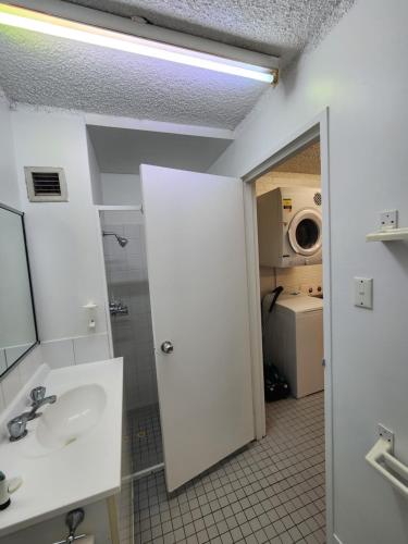 a bathroom with a sink and a mirror at Perth City Apartment Hotel in Perth