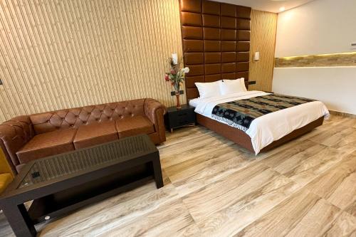 a hotel room with a bed and a couch at Lake View Resort in Pokhara