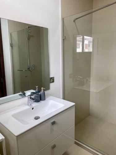 a bathroom with a white sink and a shower at Executive One Bedroom Suite Space Available in Accra