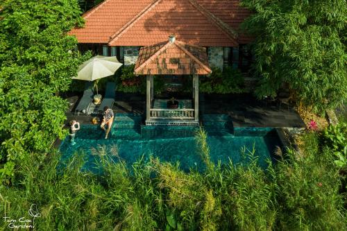 an overhead view of a house with a swimming pool and an umbrella at Tam Coc Garden Resort in Ninh Binh