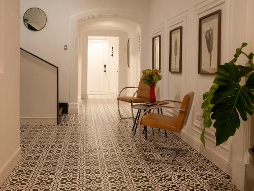a hallway with a table and chairs on a patterned floor at Blu Hotel Boutique in Lima
