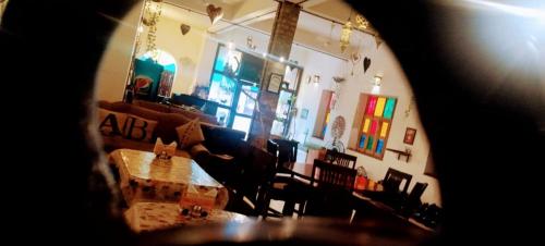 a view of a living room with a table and chairs at RANGBAARI STAYS & CAFE in Jodhpur