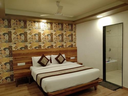 a bedroom with a bed and a shower and a tub at Mountview Resort in Lonavala