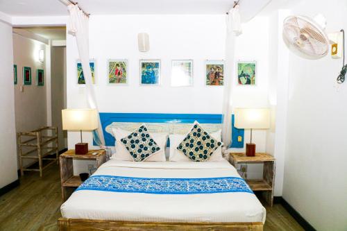 a bedroom with a blue and white bed with pillows at Esperanza Beach Mawella in Tangalle