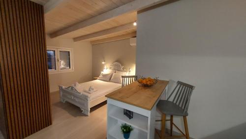 a small bedroom with a bed and a desk with a bench at GIORGIO LUXURY LOFT WITH AMAZING VIEW Of NAFPLIO in Nafplio