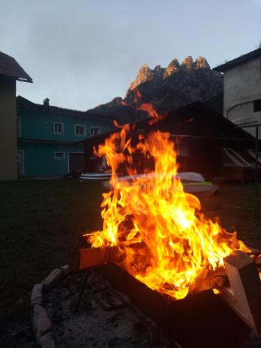 a fire burns in a yard at night at Cave Trieste Apartments - CaTs Apartments in Tarvisio