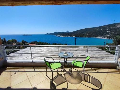 a table and chairs on a balcony with a view of the ocean at Seagulls - Within walking distance from sea! in Petriaí