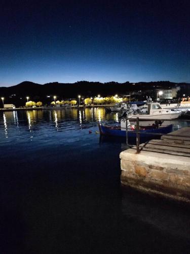 a group of boats docked in a harbor at night at Seagulls - Within walking distance from sea! in Petriaí