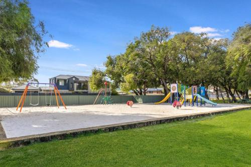 a playground in a park with a sandbox at Our Beach House- Busselton in Busselton