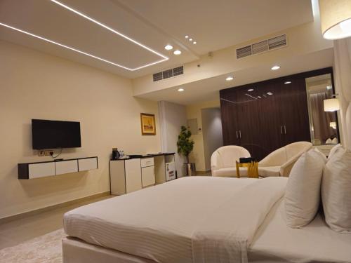 a hotel room with a bed and a tv at Clifton International Hotel in Fujairah