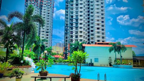 a swimming pool in a city with tall buildings at Soul Casa Homestay in Kuala Lumpur