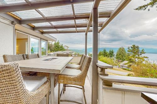 a patio with a table and chairs and a view of the ocean at Sound Views in Port Townsend in Port Townsend