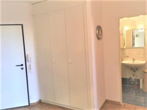 baño con lavabo y armario blanco en Apartment with Garden in Nyon, en Nyon