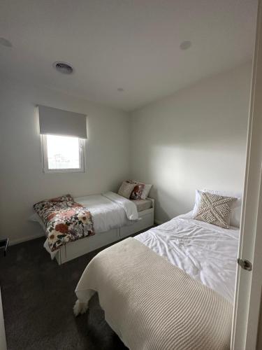 a bedroom with two beds and a window at 12 Stern Way New Gisborne in Gisborne