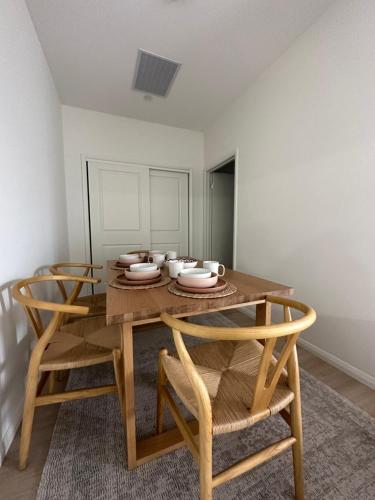 a dining room with a wooden table and chairs at 12 Stern Way New Gisborne in Gisborne