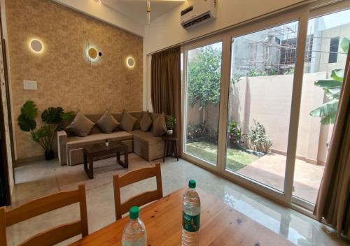 a living room with a couch and a table with two water bottles at The Sky Imperial Sethji Ni Wadi in Indore