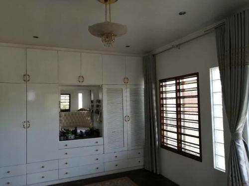 a room with white cabinets and a large mirror at Fiji-Beauty in Nadi