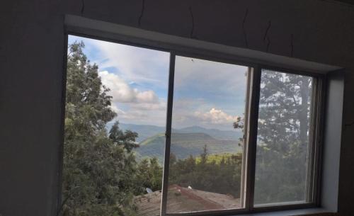 a window with a view of a mountain view at Tabletop Villa Jacuzzi Suite - valley view in Panchgani