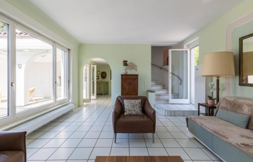 a living room with a couch and a chair at Villa Incanto in Ascona