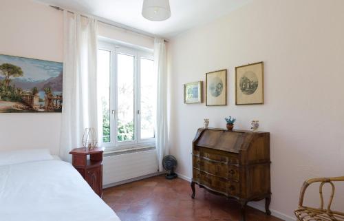 a bedroom with a bed and a window at Villa Incanto in Ascona