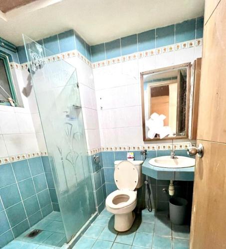 a bathroom with a toilet and a sink at lanai gurney corporate suites in Kuala Lumpur