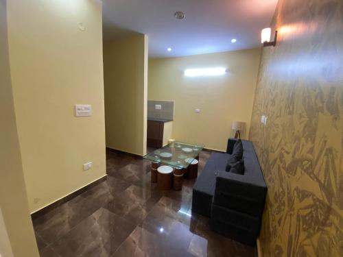 a living room with a couch and a table at Skylight homestay in Dehradun