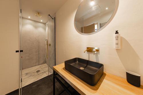 a bathroom with a black sink and a shower at Villa Totò Resort in Cefalù