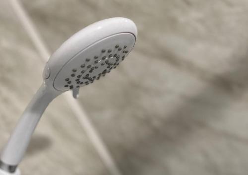 a close up of a white toothbrush at 3 Bedroom Apartment, Ballymena, The Wee Stop Gap in Ballymena
