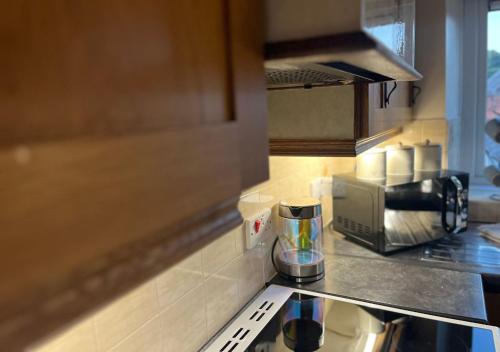 a kitchen with a counter top with a coffee maker at 3 Bedroom Apartment, Ballymena, The Wee Stop Gap in Ballymena
