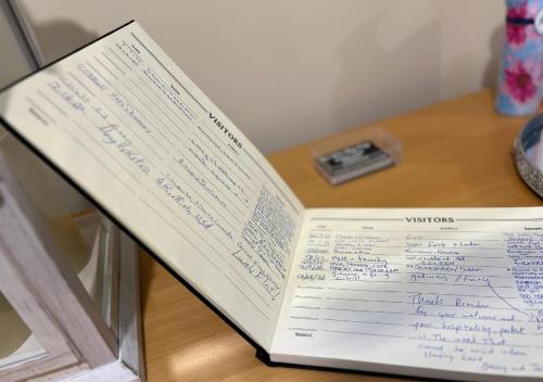 a book with writing on it sitting on a table at 3 Bedroom Apartment, Ballymena, The Wee Stop Gap in Ballymena