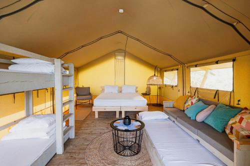 a room with two bunk beds and a bed at Layla Glamping in Nir Dawid