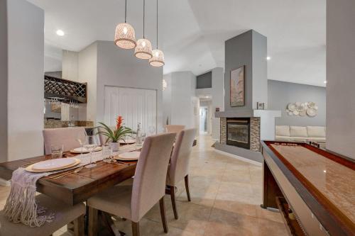 a dining room with a table and chairs and a fireplace at Mirage Pool House - Heart of LV, Swimming Pool, Games, heavenly relaxation in Las Vegas