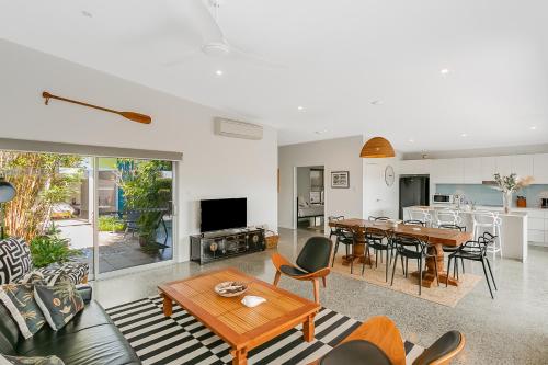 a living room with a couch and a table at Zen Garden Beach House Casuarina by uHoliday in Casuarina