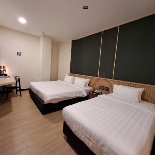 Ένα ή περισσότερα κρεβάτια σε δωμάτιο στο Urban Inn, Alor Setar